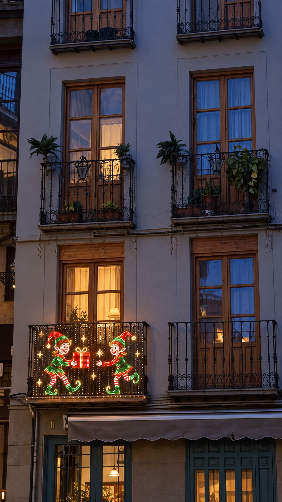 Pixel displays lit on two balconies of a building at dusk