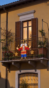 Pixel nutcracker lit on a balcony railing